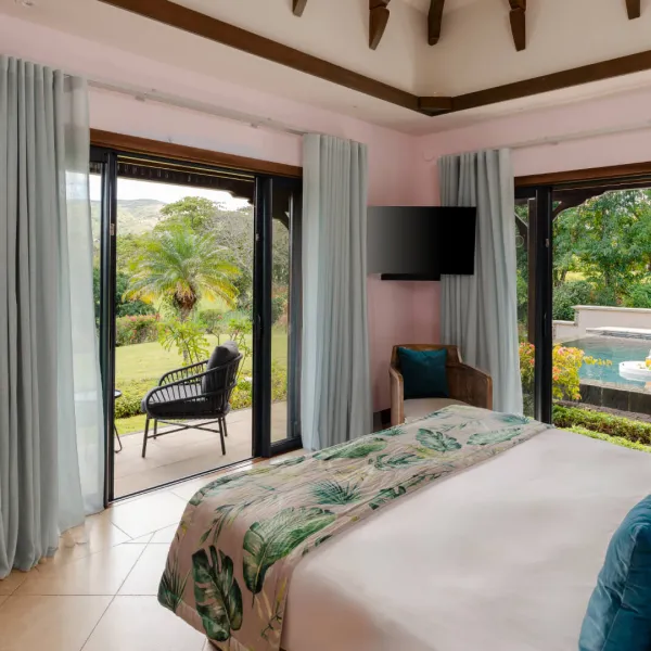 Bedroom with poolside view in a luxury 4-bedroom villa