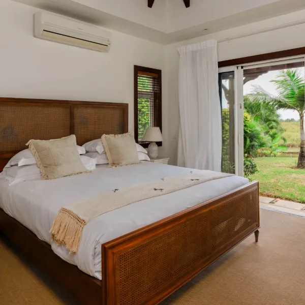 Bedroom in a luxury four-bedroom villa featuring views to the outdoor surroundings