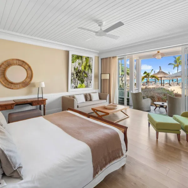 deluxe beachfront adult-only suite bedroom with outdoor view at heritage le telfair mauritius