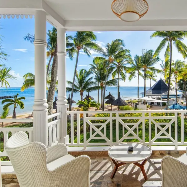 deluxe suite upper floor with ocean facing balcony and comfortable outdoor seating space