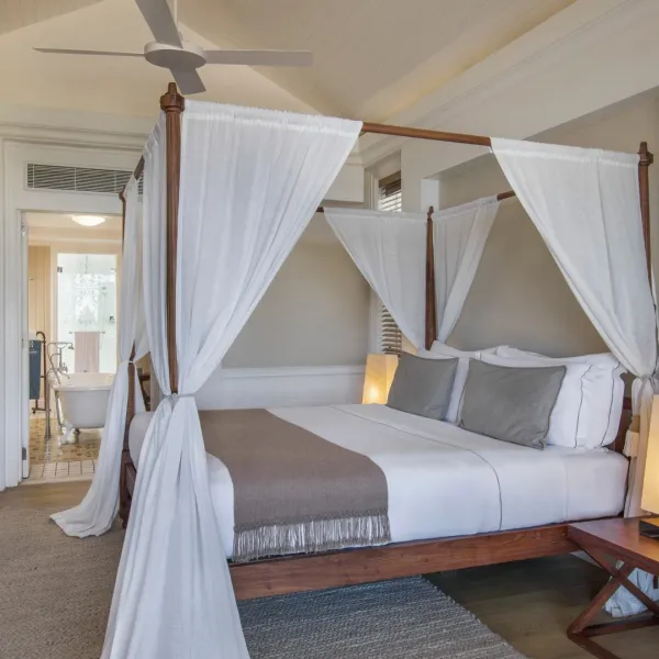 ocean beachfront suite bedroom with kingsize bed direct access to beach at heritage le telfair mauritius