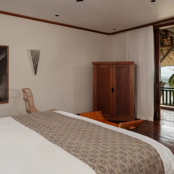 beachfront villa bedroom with private balcony overlooking the ocean