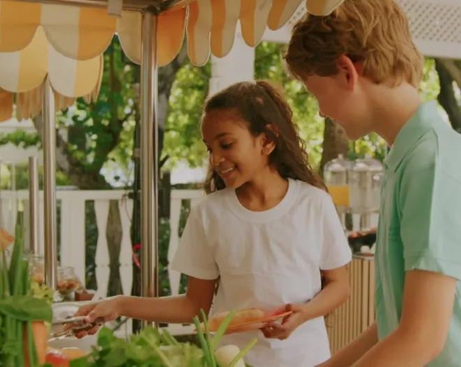 Kids smiling fresh food  outdoor buffet setting 