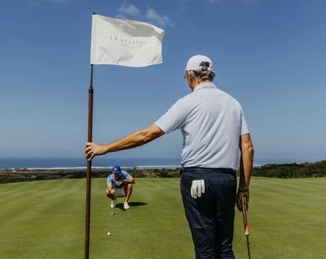 Golfers teeing off at La Réserve Golf Links in Mauritius