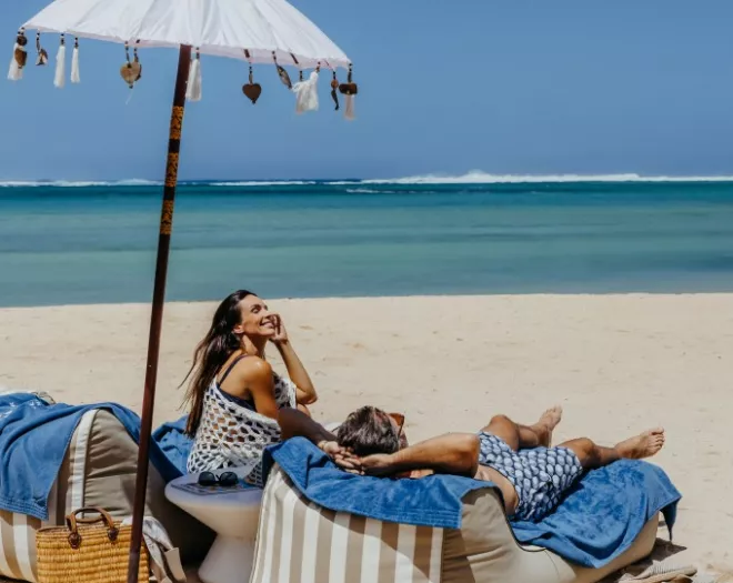 relaxed couple lounging on serene beach