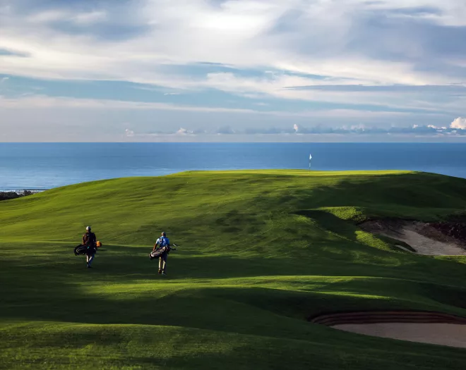 golfers walking  at la réserve golf links heritage mauritius