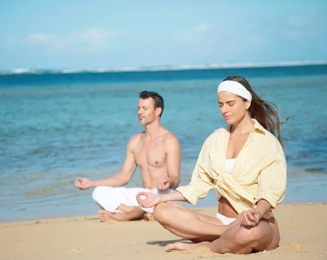morning yoga on the beach sand at heritage resorts mauritius