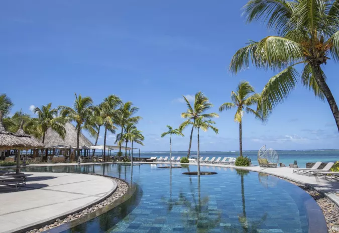 Exterior view of Heritage Awali resort with tropical landscaping and traditional architecture