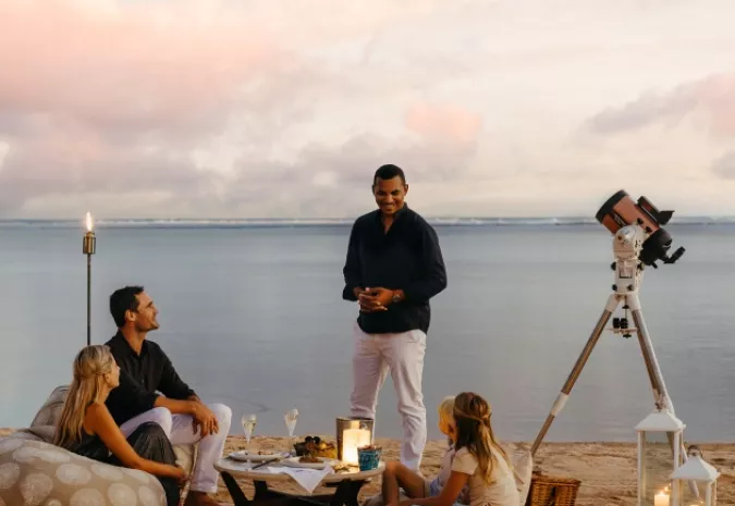 Family enjoying a celestial stargazing experience at night